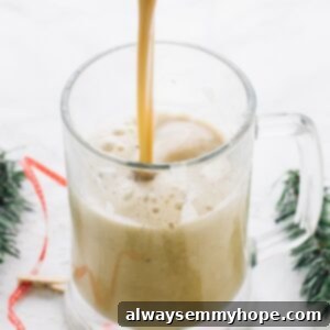 Adult Yuletide Spiced Eggnog 2 A charming close-up of Spiced Eggnog in a glass mug, with a hint of festive flair.
