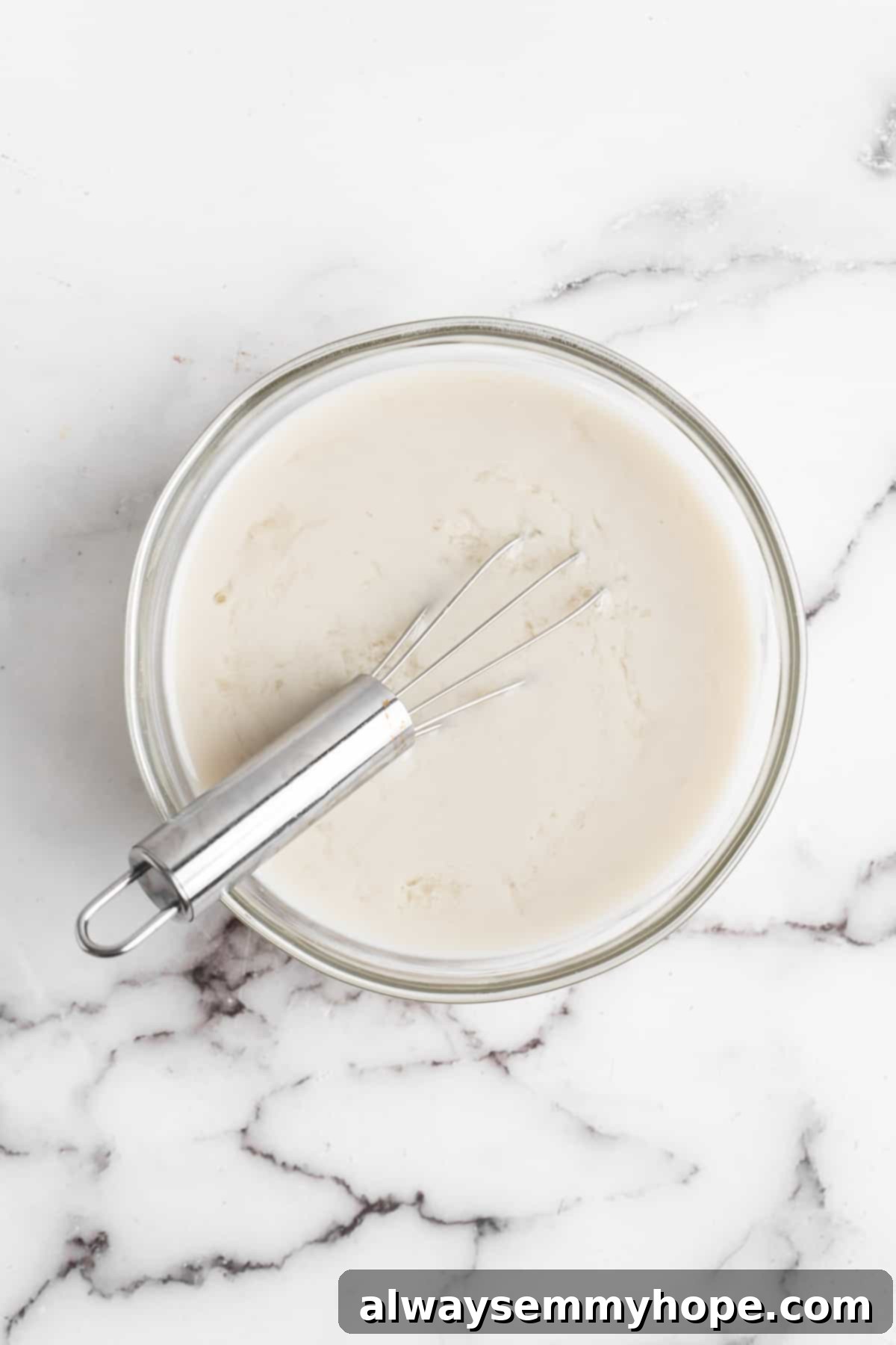 This vegan chocolate cake recipe is the best you'll ever try and the easiest too! Make it yourself and find out why it's a reader favorite. Whisking soy milk and vinegar in glass bowl.