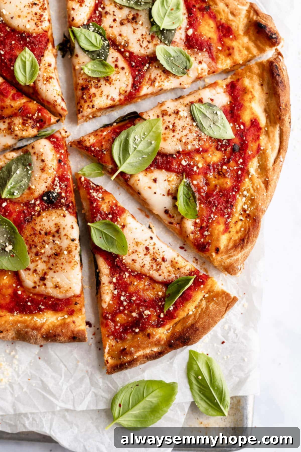 overhead shot of vegan pizza sliced with one slice slightly pulled out, ready to be served