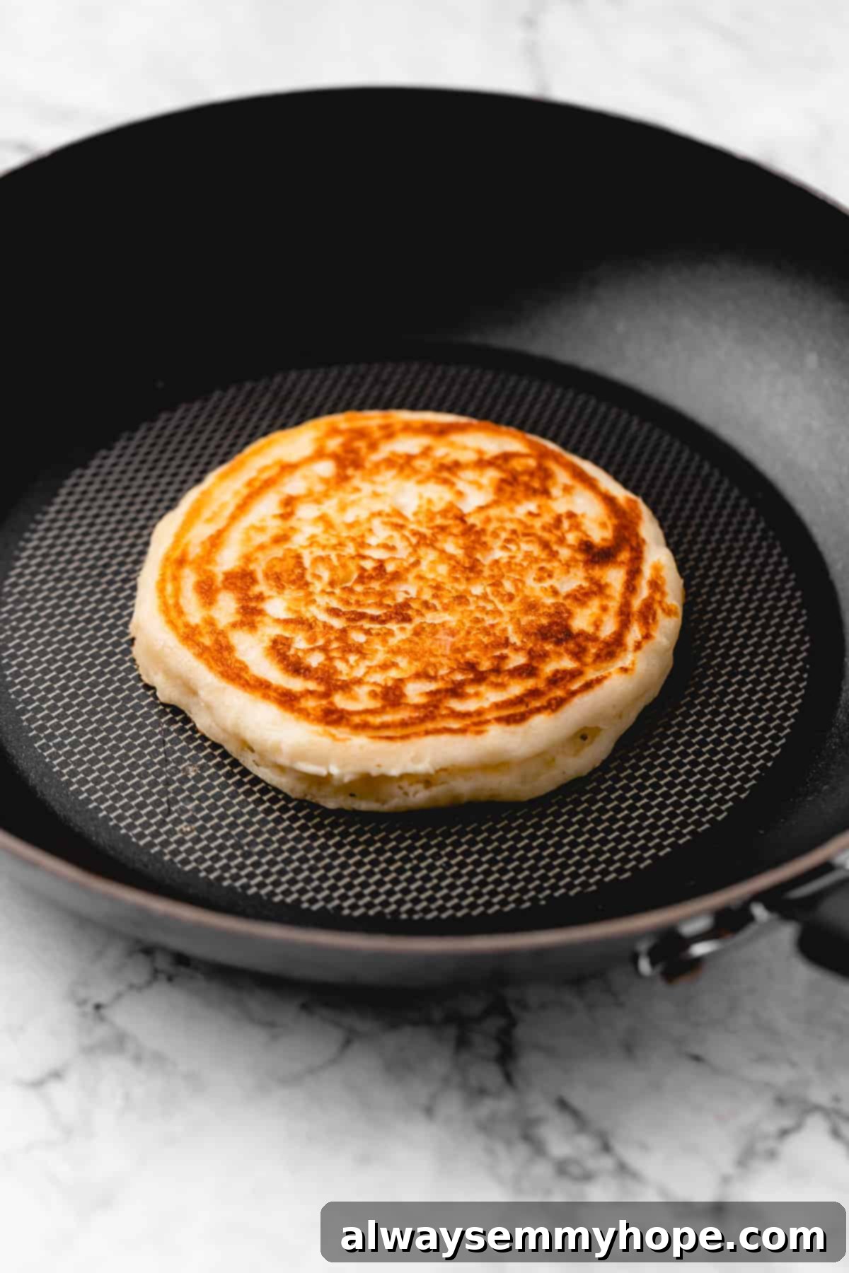 Golden brown pancake in a skillet.