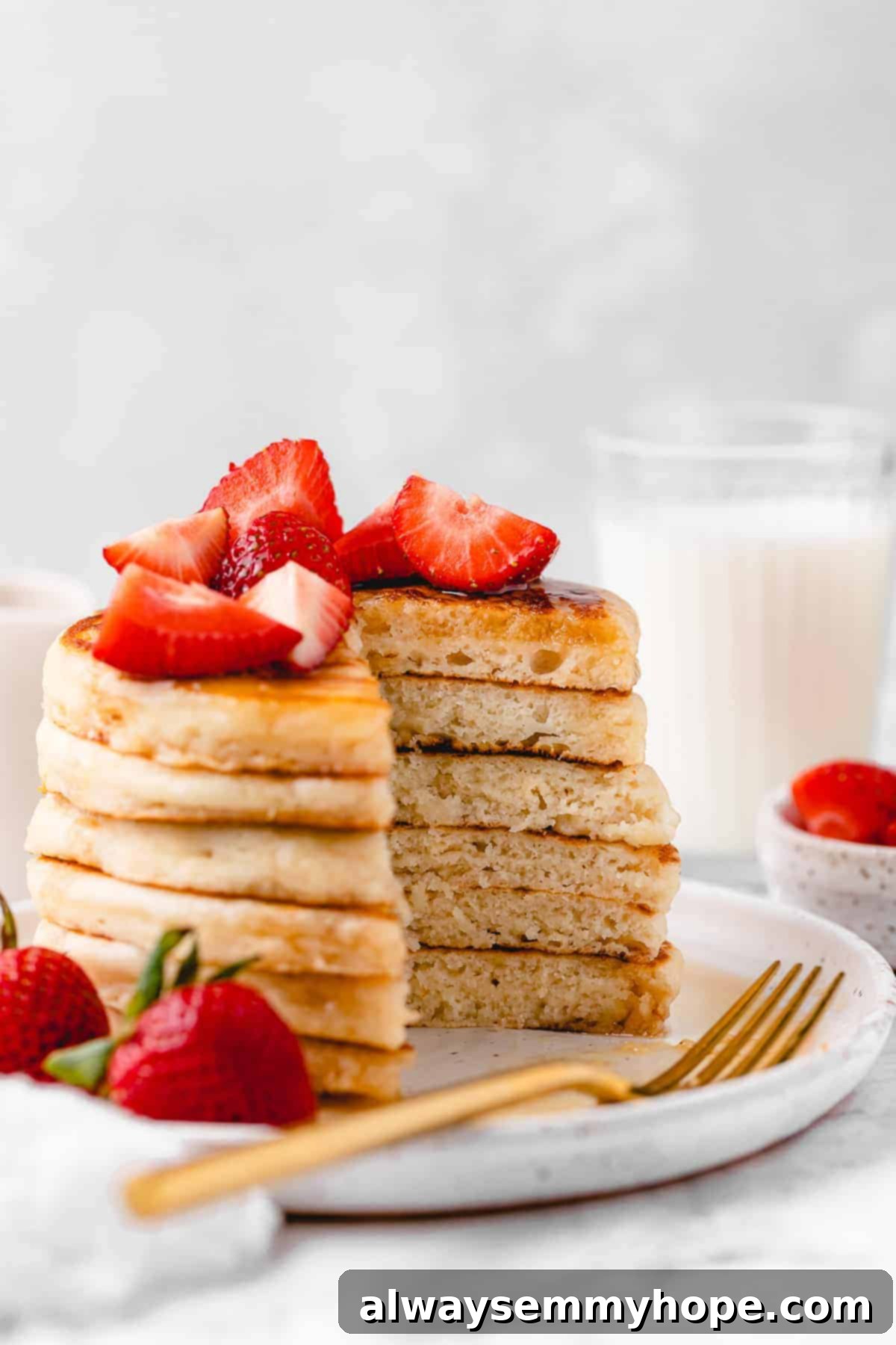 Fluffy vegan pancakes with chopped strawberries.