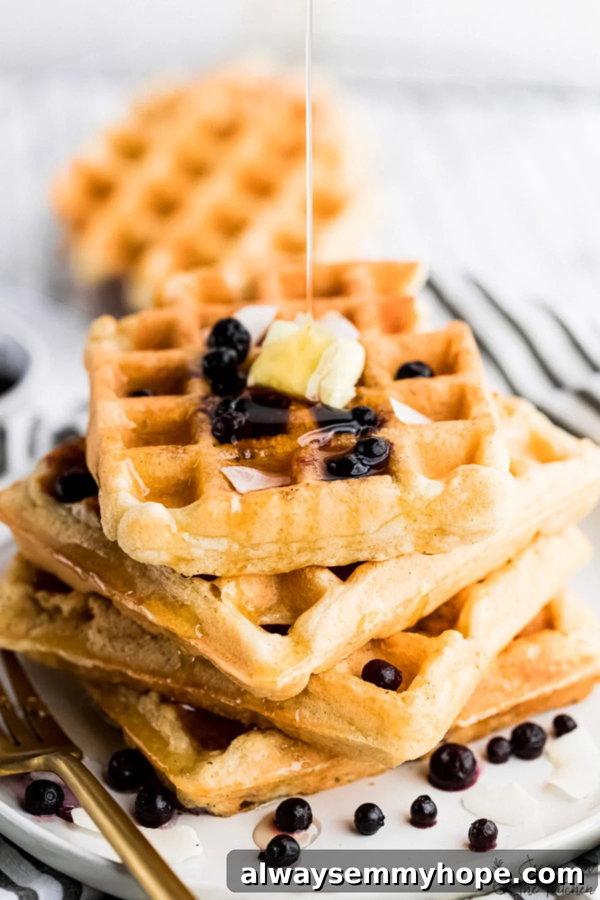 Irresistibly Fluffy Crispy Vegan Waffles 2 Stack of golden vegan waffles drizzled with maple syrup