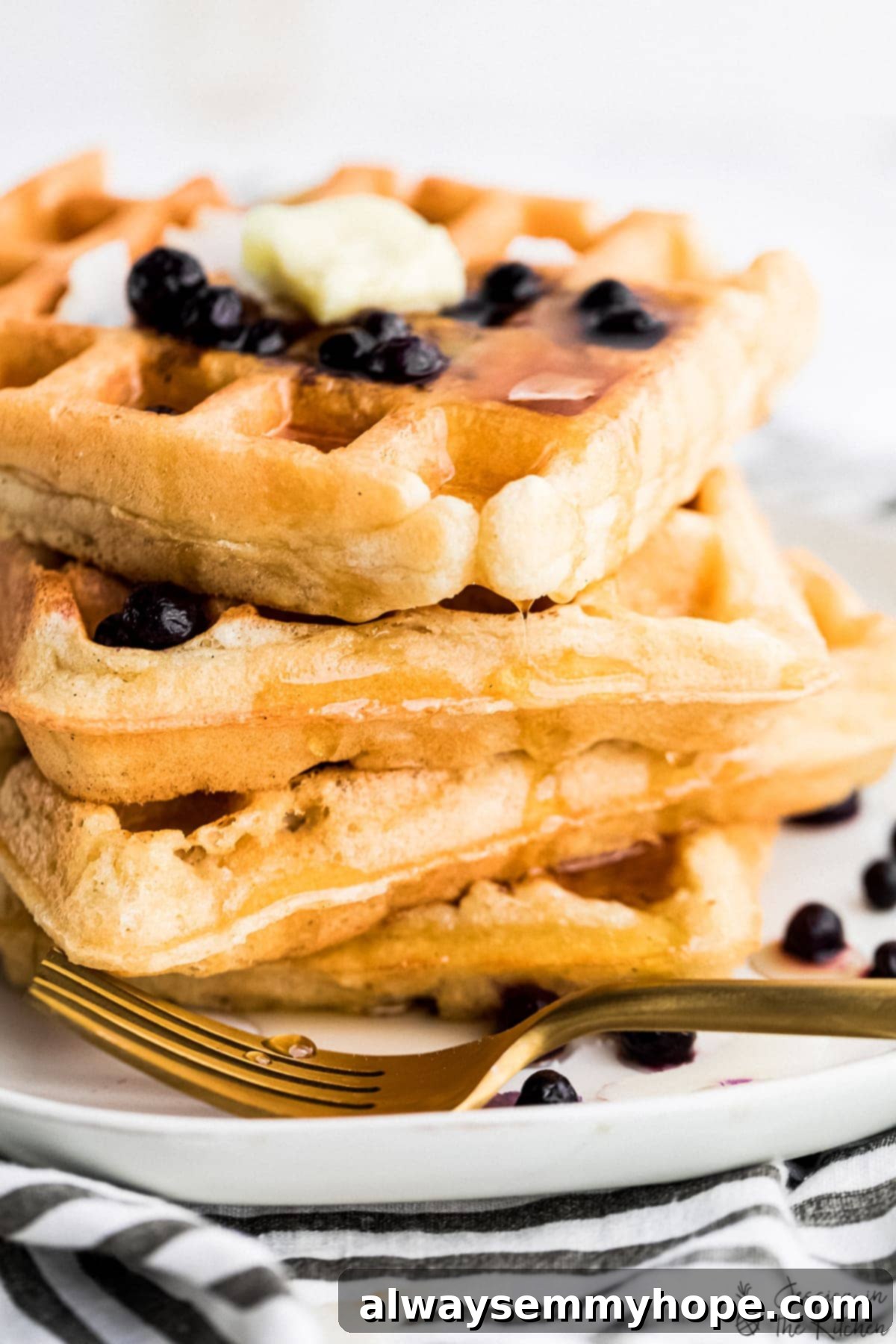 Irresistibly Fluffy Crispy Vegan Waffles 6 Close-up shot of perfectly stacked vegan waffles with a generous drizzle of syrup