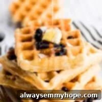 Irresistibly Fluffy Crispy Vegan Waffles 7 vegan waffles stacked on top of each other with maple syrup drizzle on top