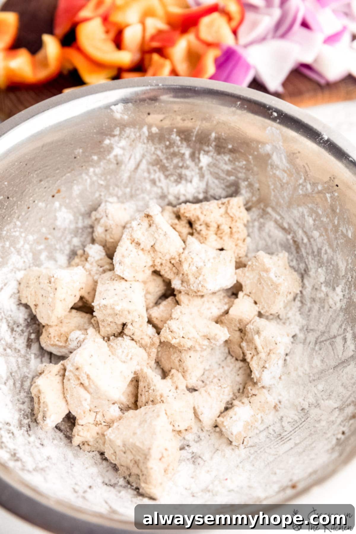 Crispy Vegan Sweet and Sour Tofu 3 Tofu pieces expertly battered with cornstarch, ready for frying to achieve maximum crispiness.