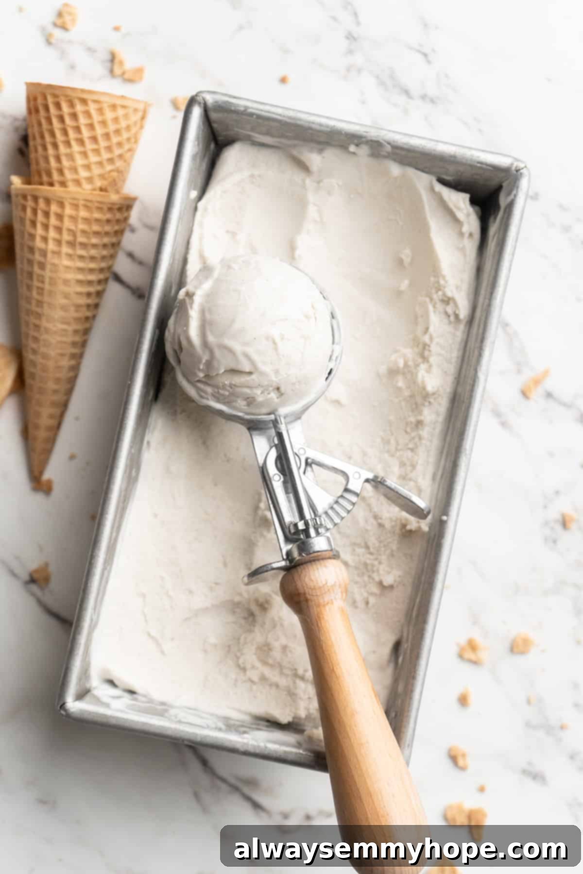 Cover this homemade vegan ice cream very tightly to prevent ice particles from forming. It will keep fresh in the freezer for up to 2 weeks. Overhead view of a vegan ice cream scoop carefully placed in a loaf pan, showcasing its creamy texture