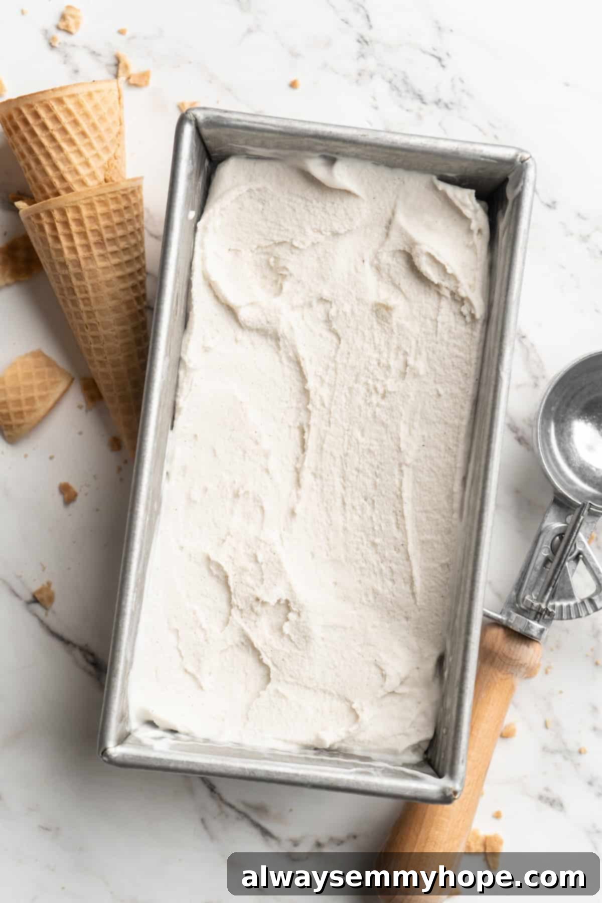 Cover this homemade vegan ice cream very tightly to prevent ice particles from forming. It will keep fresh in the freezer for up to 2 weeks. Overhead view of set vanilla vegan ice cream in a loaf pan, perfectly ready for scooping