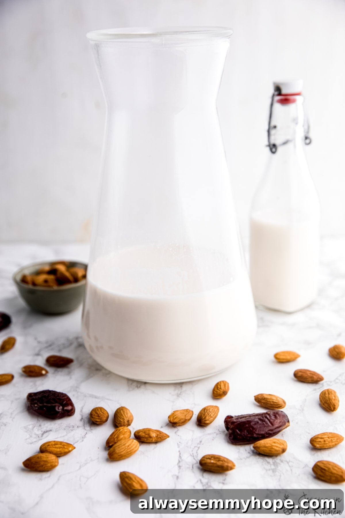 Carafe of homemade almond milk, showcasing its creamy texture
