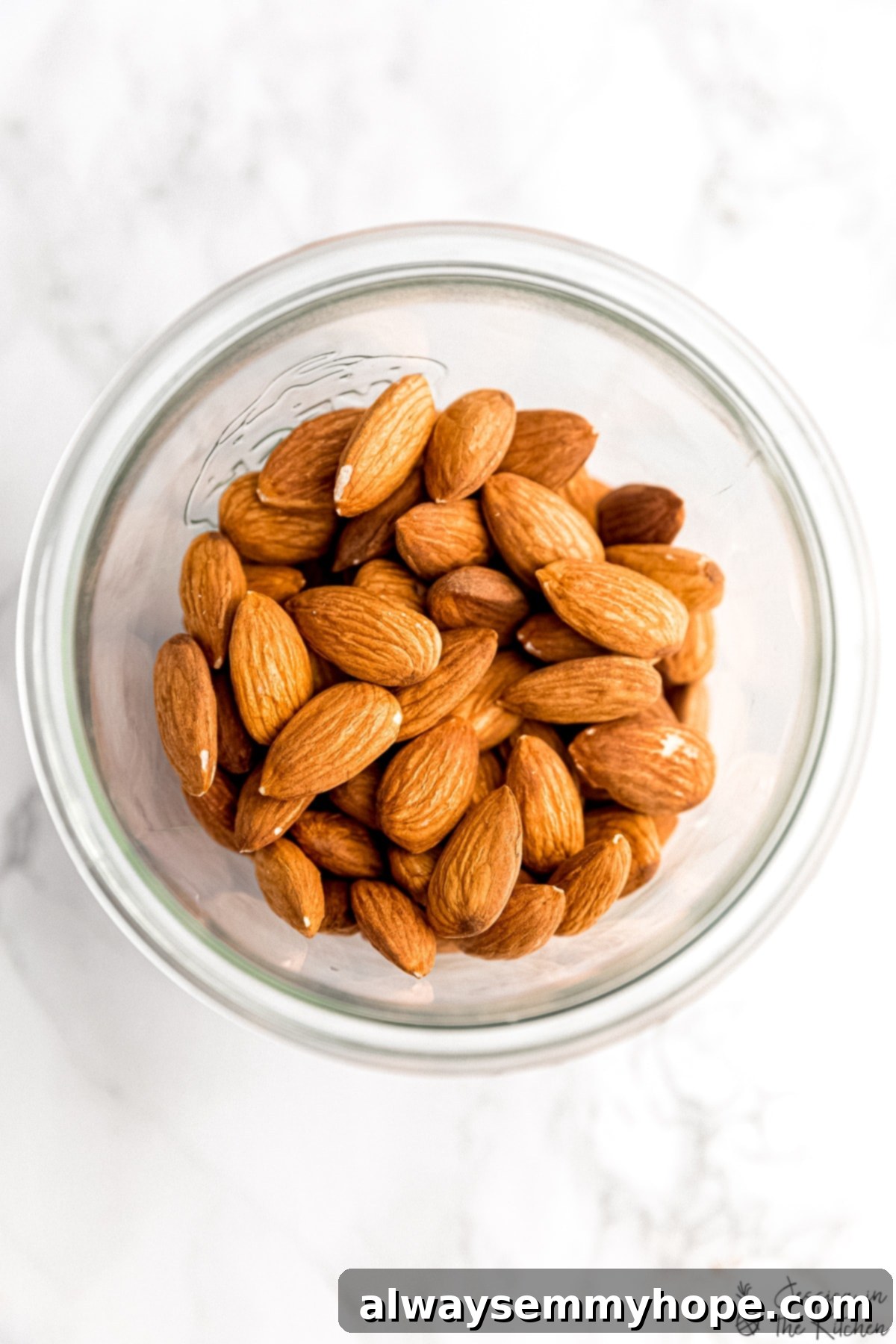 Overhead view of raw almonds in a glass jar, ready for soaking