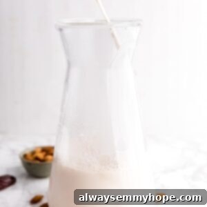 Almond Elixir 2 Almond milk being poured into a jar with raw almonds and dates surrounding it.
