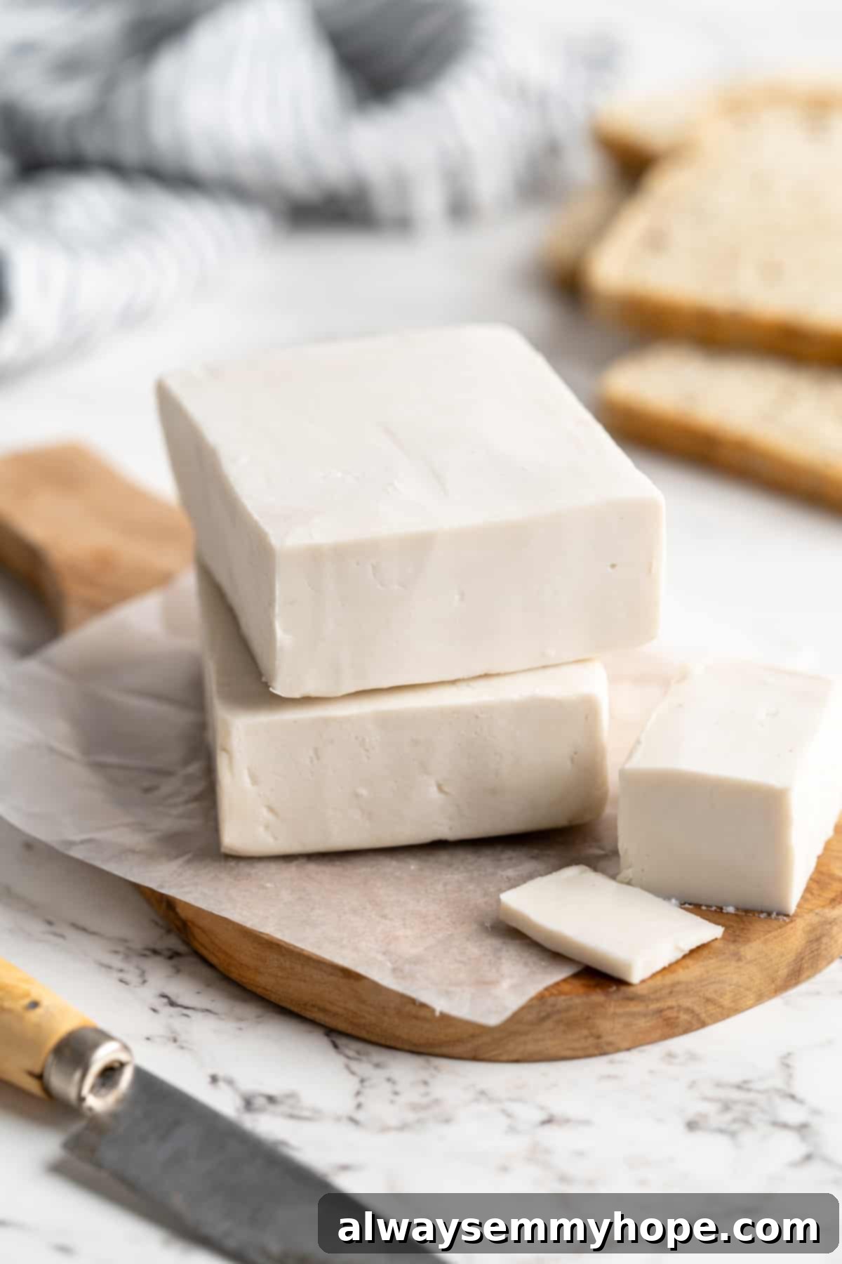 Homemade vegan butter blocks stacked neatly on a rustic wooden cutting board, ready for use.