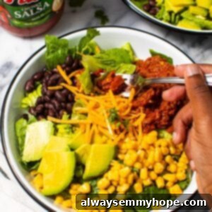 Digging into bowl of vegan taco salad