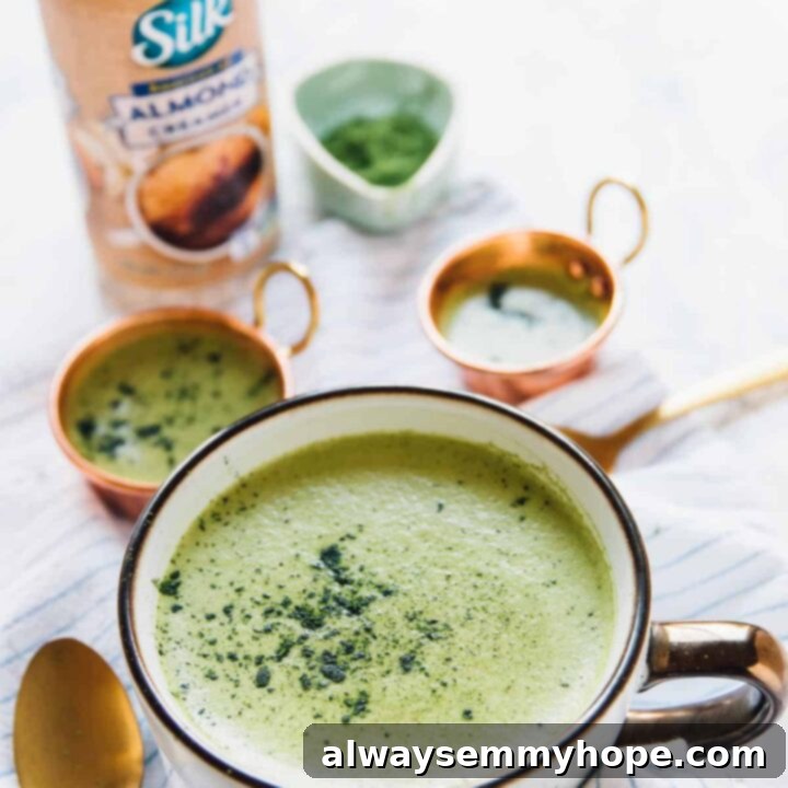 A vibrant green Pumpkin Spice Matcha Latte in a glass mug.