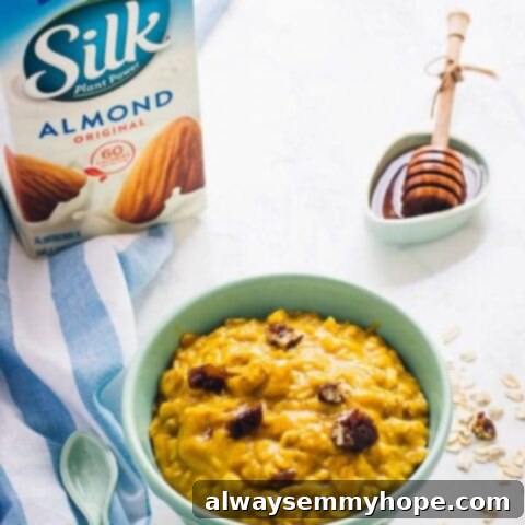 A jar of Pumpkin Pie Overnight Oats with a spoon.