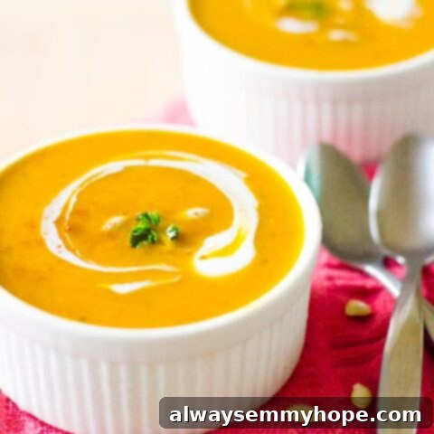 A bowl of creamy Vegan Pumpkin Soup garnished with fresh herbs.