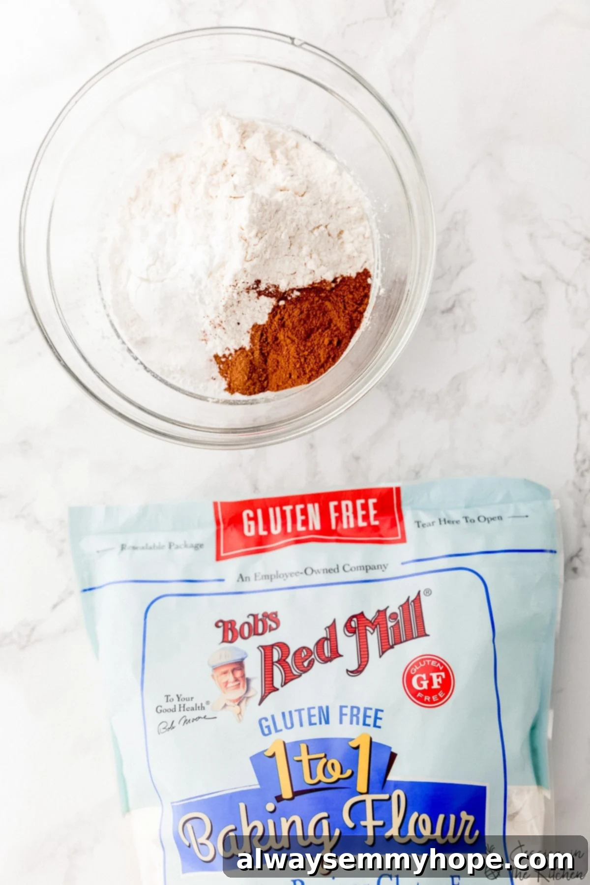 Dry ingredients for a muffin recipe with a bag of Bob's Red Mill Baking Flour birds eye view.