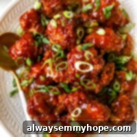 Crispy BBQ Cauliflower Bites 2 Bbq cauliflower wings on a plate with a spoon beside it.