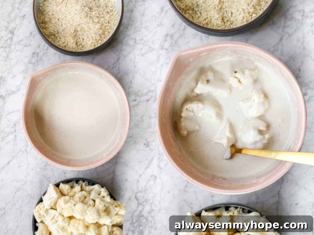 BBQ cauliflower wings are perfect for game day appetizers or make them your main dish on a weeknight. So easy and delicious! Top down shot of cauliflower florets in wet ingredients.