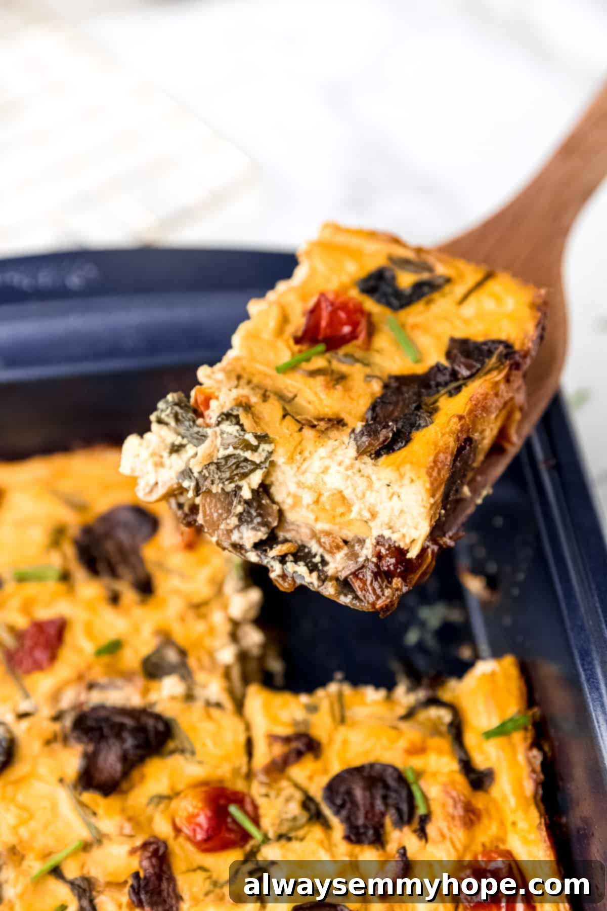 Slice of frittata being lifted out of the baking pan.
