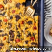 Vegan frittata in a baking sheet with fork and spoon in it.