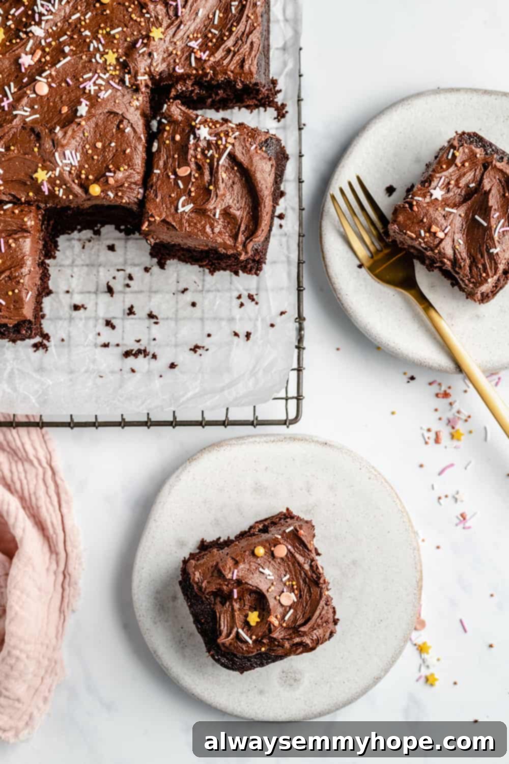 Two plates each with a square of vegan chocolate sheet cake, garnished with sprinkles, ready for serving.