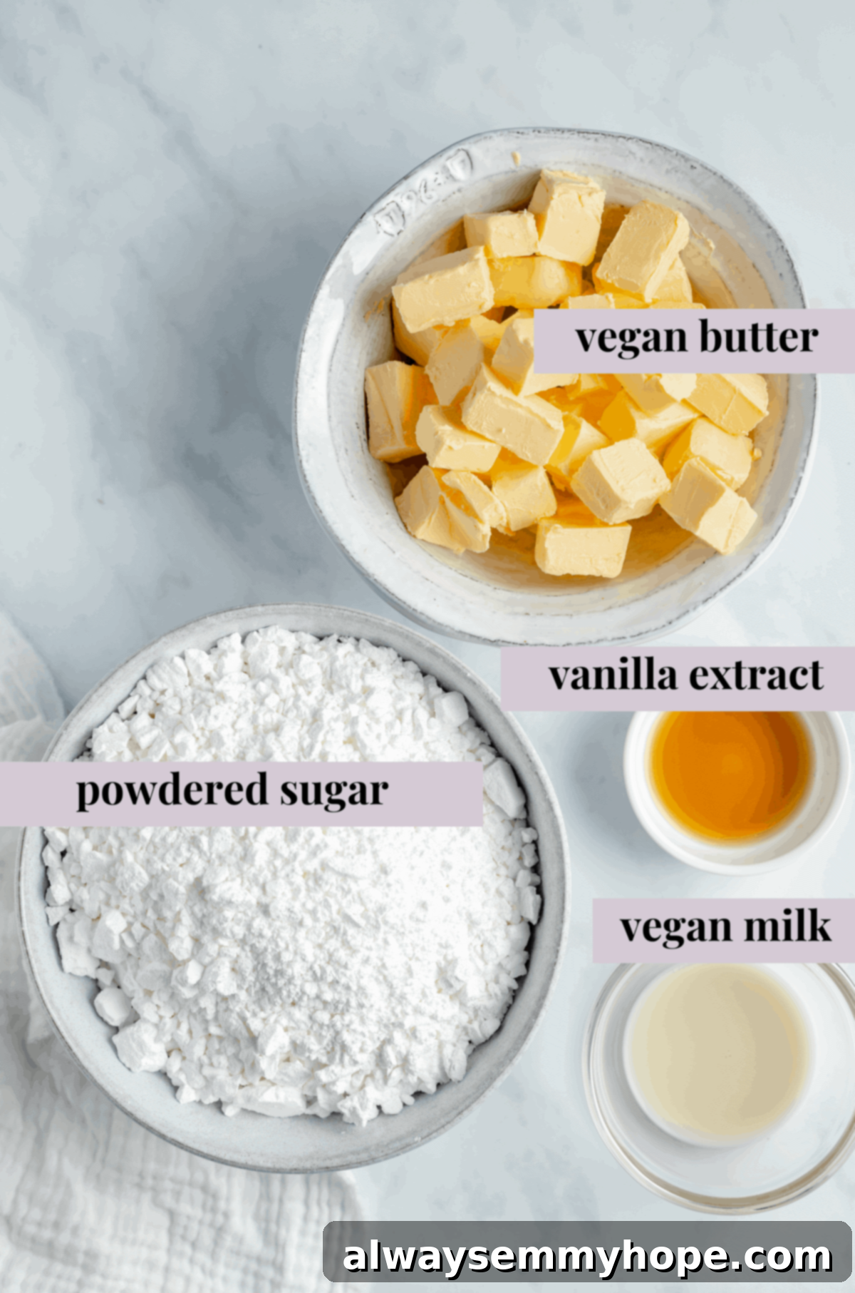 Craft the silkiest vegan buttercream with these simple ingredients. The perfect topping for your homemade vegan vanilla cake. Ingredients for a luscious vegan buttercream frosting, including sifted powdered sugar, softened vegan butter, and pure vanilla extract.