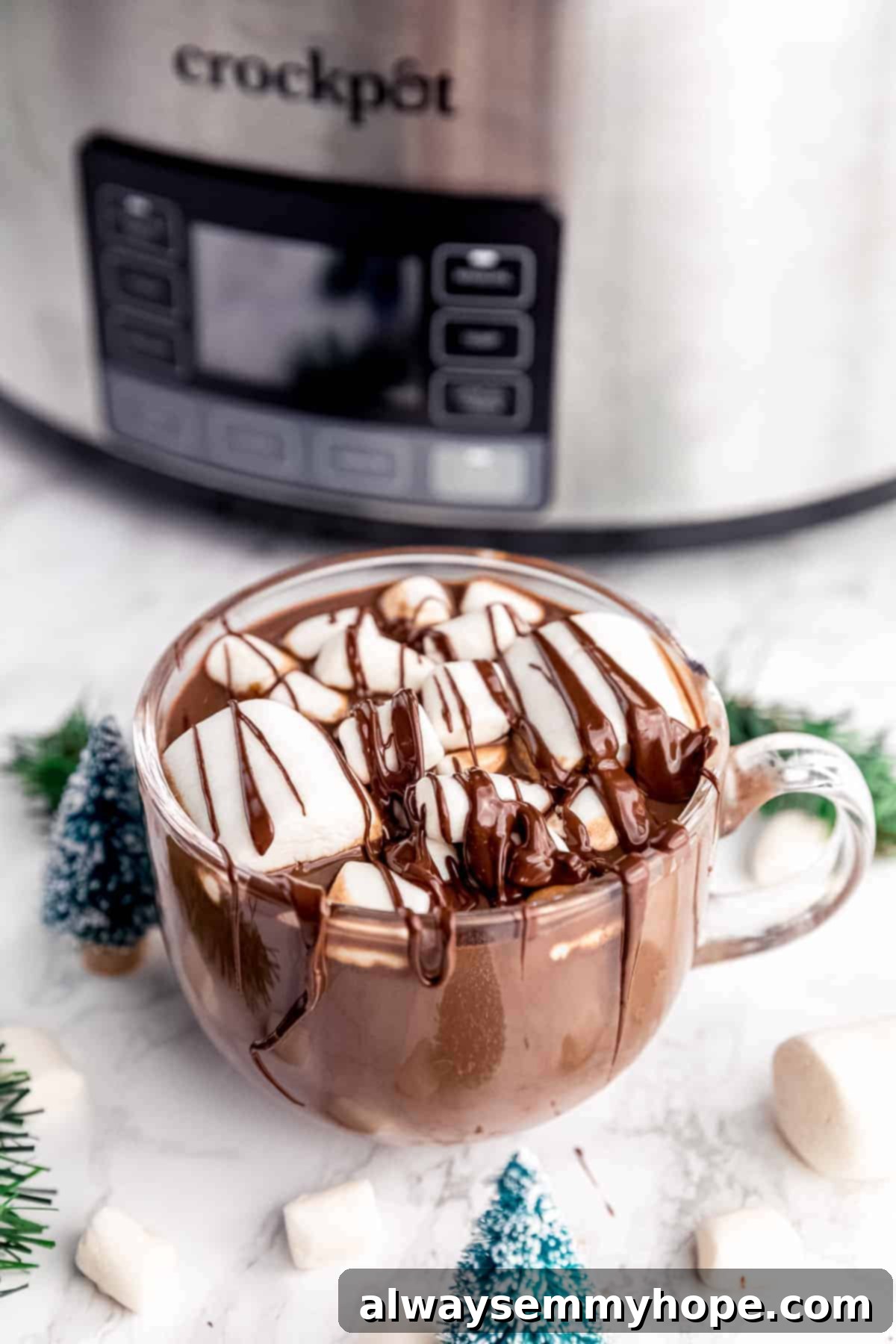 Experience rich, creamy, and vegan slow cooker hot chocolate, effortlessly made with coconut milk for quick prep and crowd-pleasing results! A beautifully presented mug of slow cooker vegan hot chocolate topped with coconut whipped cream and cinnamon