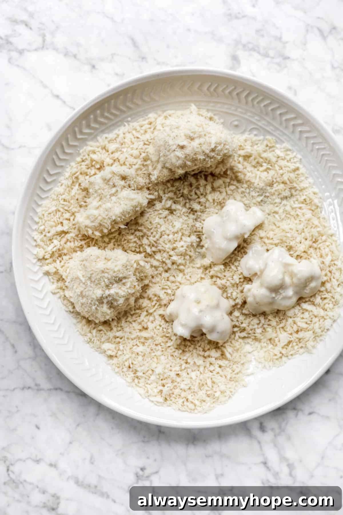 Crispy Sweet and Sour Cauliflower Wings 7 An overhead view of cauliflower florets generously coated in breadcrumbs, ready for baking to become crispy wings.