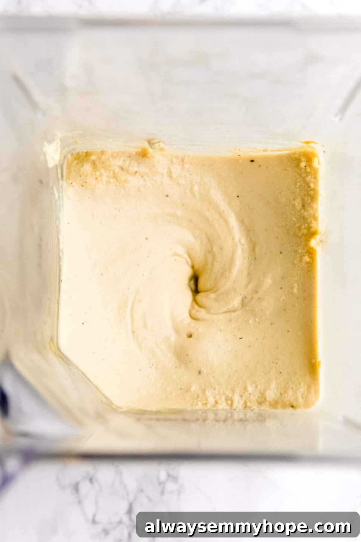 Wholesome Vegan Shakshuka 7 A birds-eye view of a blender with the creamy vegan tofu egg mixture, ready to be added to the shakshuka, showcasing its smooth, consistent texture.