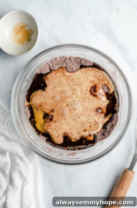 Decadent Dairy-Free Chocolate Cupcakes 5 vegan chocolate cupcakes batter ingredients being mixed in a bowl