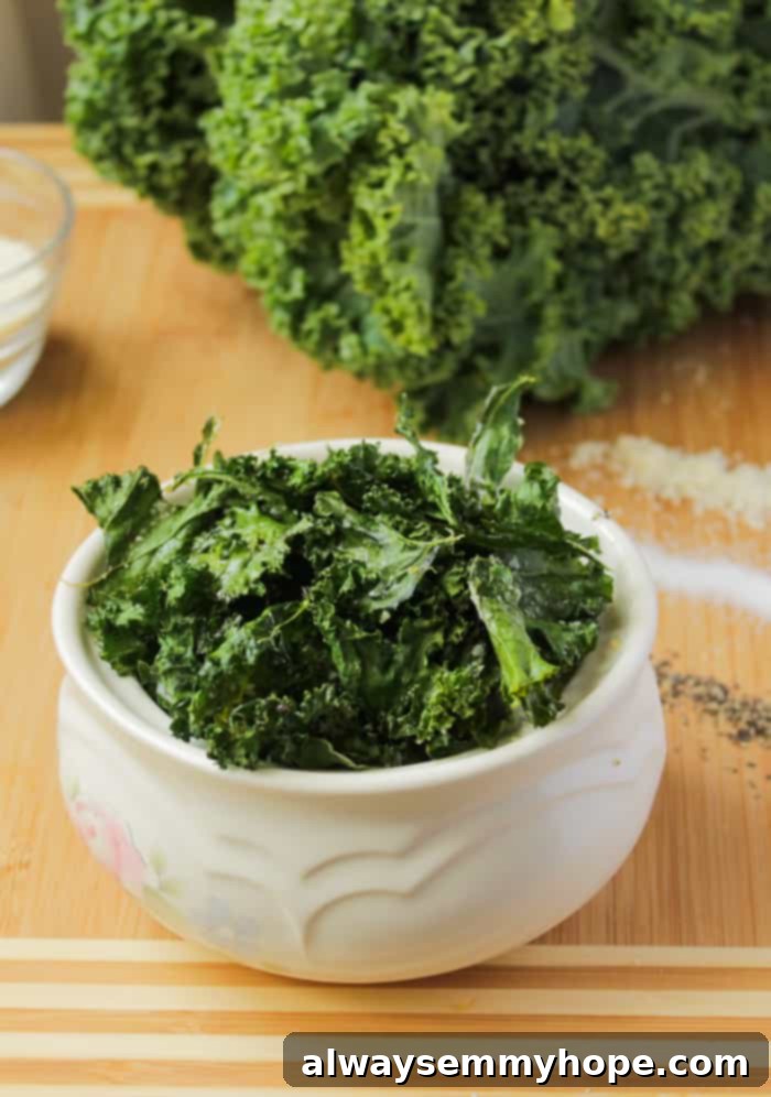 Homemade Kale Chips: A healthy, crispy alternative to potato chips, seasoned to perfection. Crispy seasoned kale pieces in a white bowl, ready to be enjoyed.