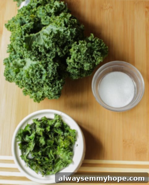 Kale chips and fresh kale on a rustic wooden board, highlighting the transformation. Top-down shot of vibrant green kale chips alongside fresh kale leaves on a wooden board.
