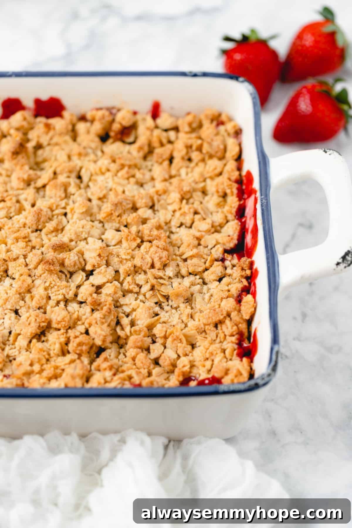 Perfectly Baked Golden-Brown Strawberry Crisp Baked strawberry crisp, fresh out of the oven, with a golden-brown, bubbly topping and visible juicy red strawberry filling peeking through.