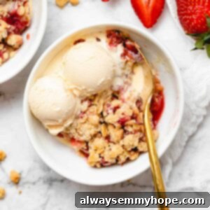Easy 7 Ingredient Vegan Strawberry Crisp 2 Overhead view of a bowl of vegan strawberry crisp topped with ice cream.