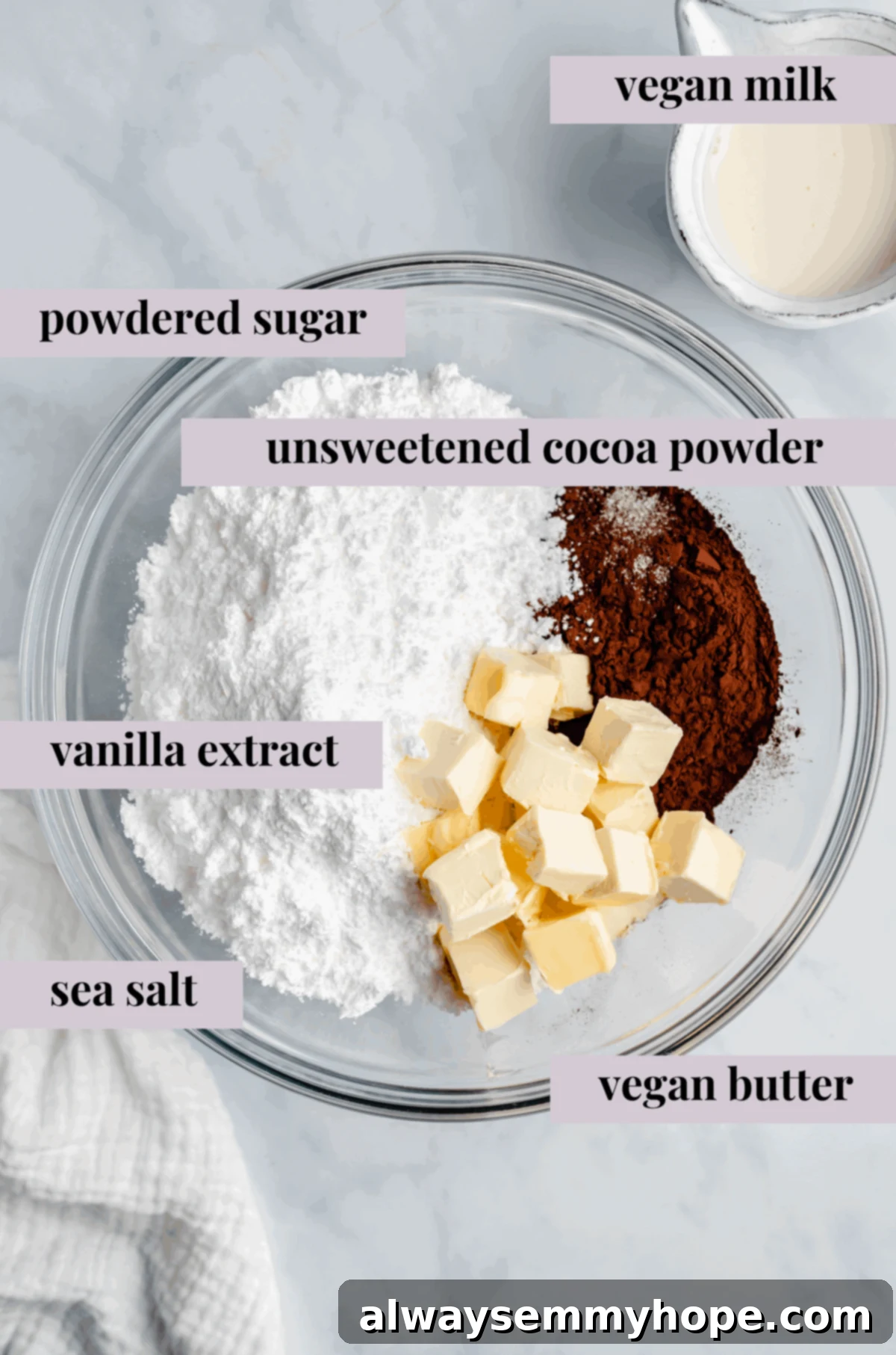Various ingredients for vegan chocolate frosting: powdered sugar, cocoa powder, vanilla extract, salt, and vegan butter in separate glass bowls