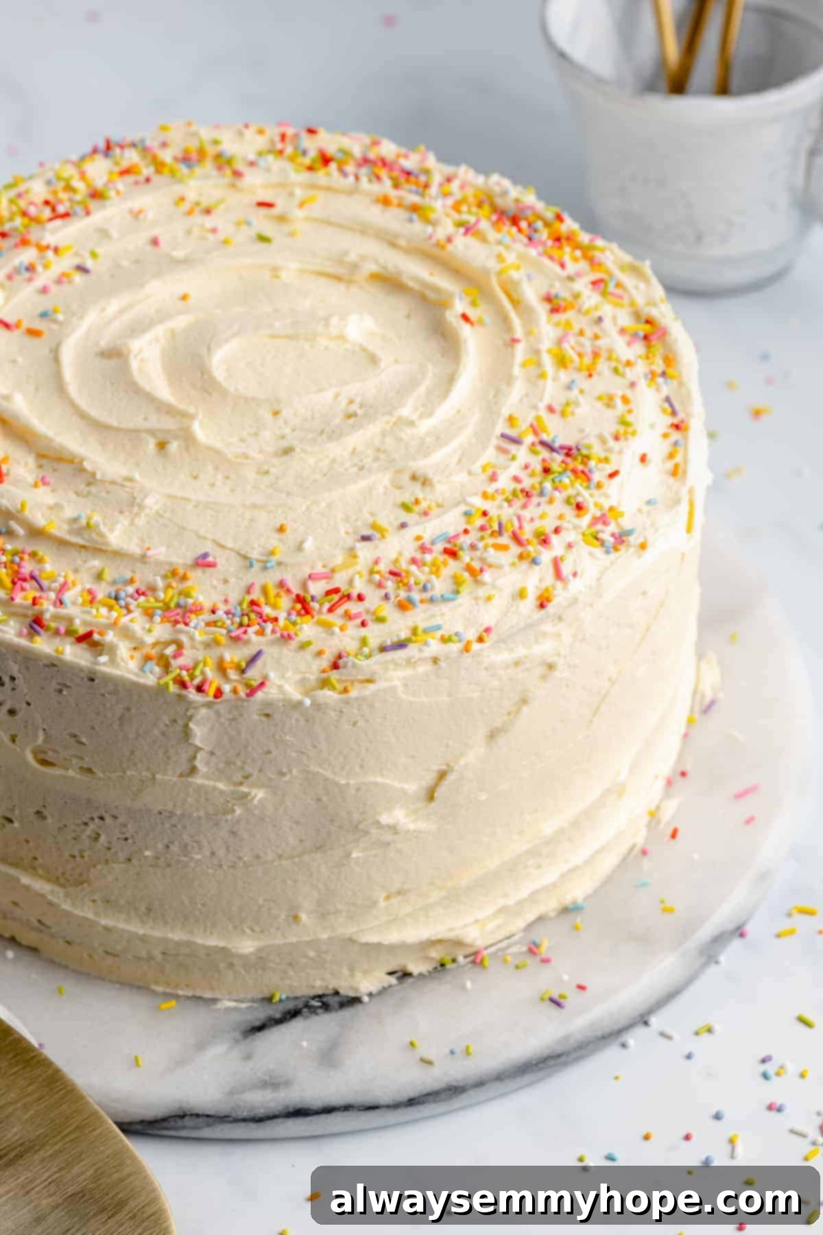 Easy 4 Ingredient Vegan Buttercream Frosting 7 vegan vanilla cake on a stand with vegan buttercream frosting