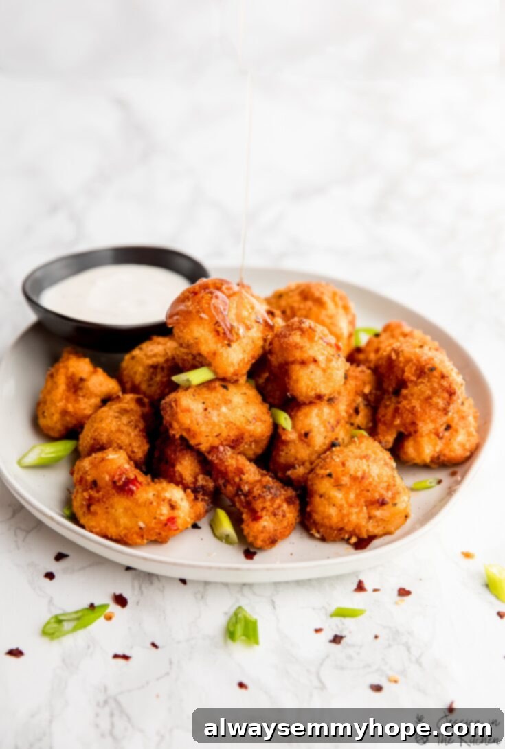 Crispy vegan Bang Bang cauliflower wings with sweet chili mayo sauce, baked or air-fried.