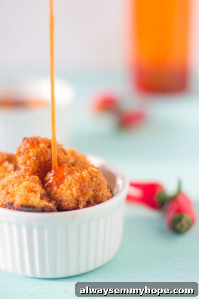 Cauliflower bites coated in a sweet and spicy Sriracha sauce, perfect for dipping.