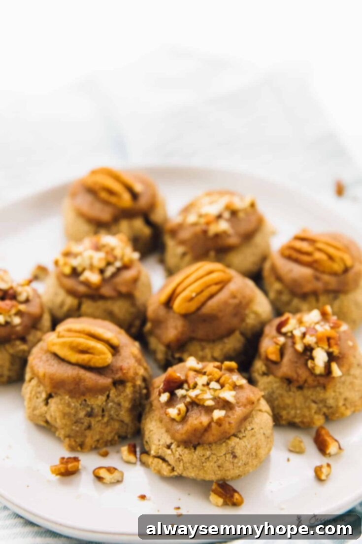 13 Irresistible Vegan Cookie Recipes 13 Elegant maple pecan sugar cookies with a creamy vegan frosting, garnished with pecan pieces, perfect for holiday gatherings.