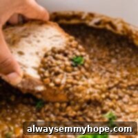 Bread dipped into a pot of lentil stew.