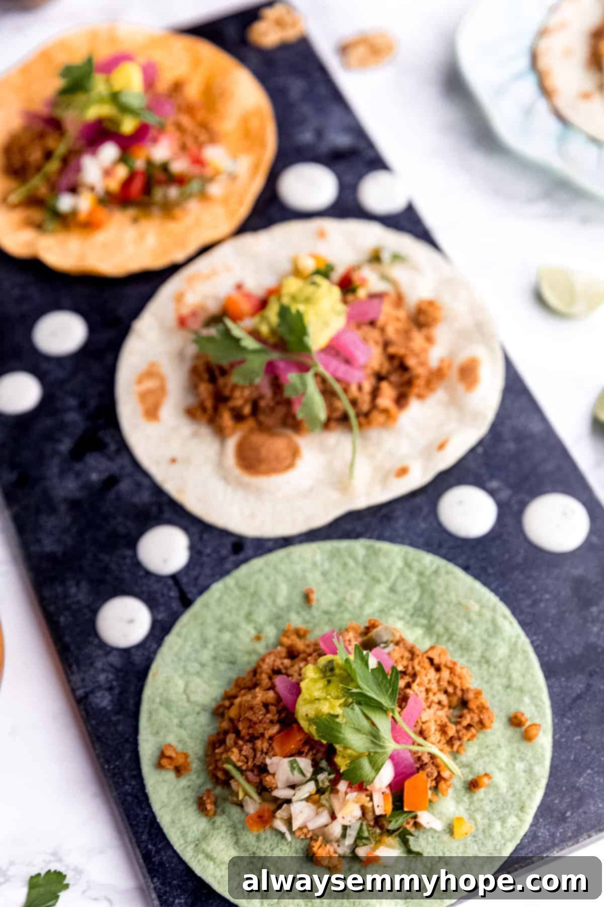 Irresistible Vegan Tacos 17 Three colorful tortillas—orange, green, and white—each filled with rich walnut meat.