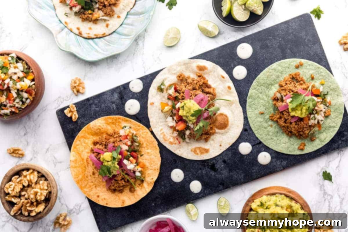Irresistible Vegan Tacos 3 Close-up of three tortillas filled with savory ground walnut meat, ready for toppings.