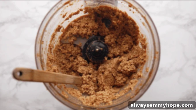 Irresistible Vegan Tacos 8 Finely blended walnut meat showcased within a food processor bowl.