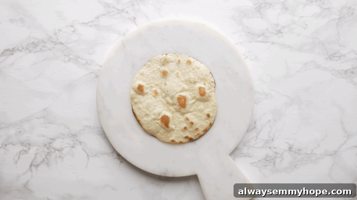 Irresistible Vegan Tacos 10 A freshly cooked tortilla resting on a cutting board, ready for fillings.