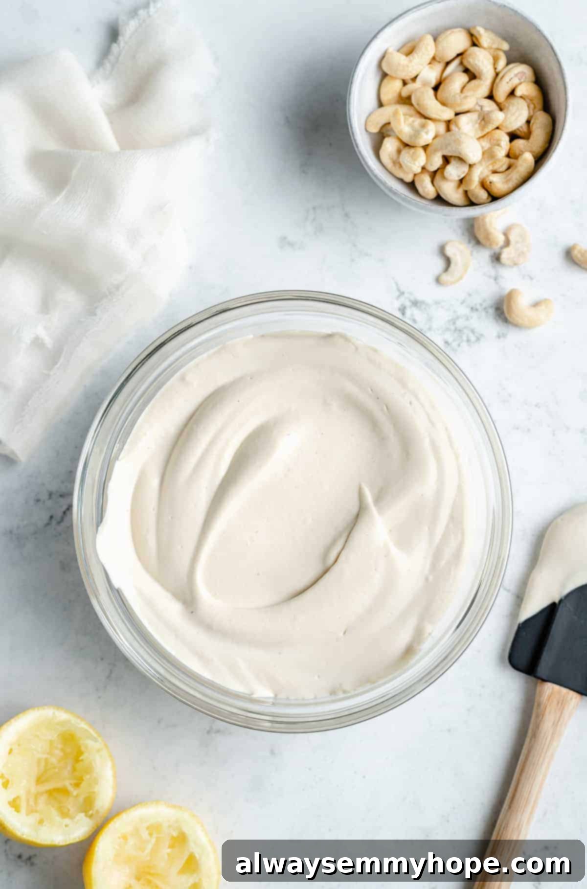 Blended vegan cream cheese mixture carefully transferred into a clear glass bowl, ready for the fermentation process.