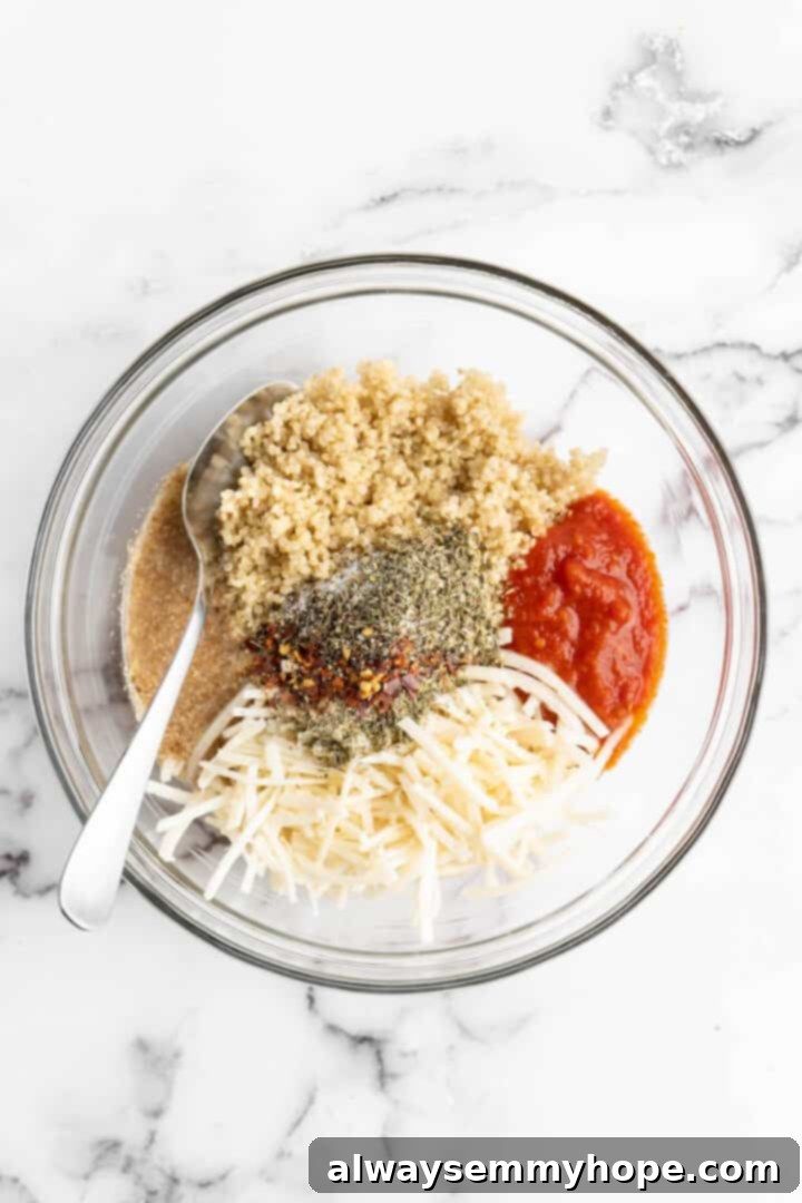 Quinoa Pizza Poppers 2 Overhead view of quinoa pizza bite ingredients gathered in a large glass mixing bowl