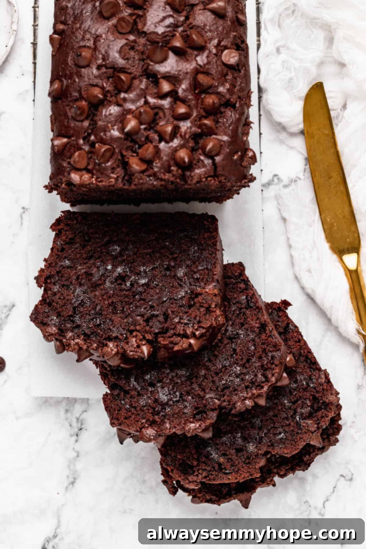 Fudgy Vegan Chocolate Banana Bread 13 Beautifully sliced loaf of vegan chocolate banana bread cooling on a wire rack.