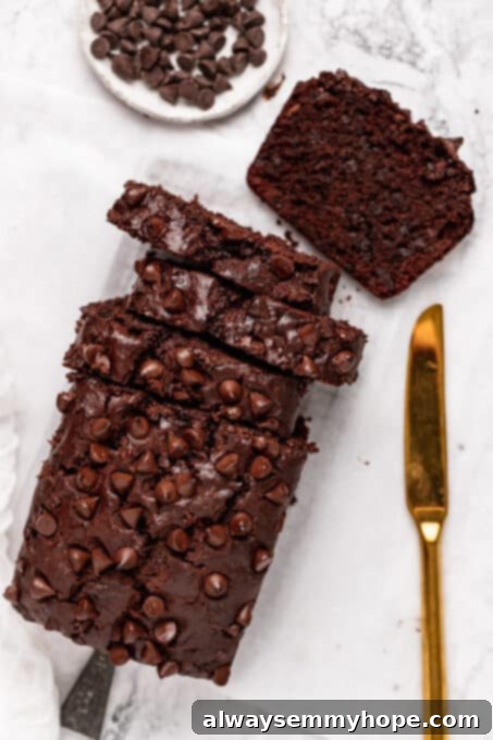 Fudgy Vegan Chocolate Banana Bread 14 Freshly cut slices of chocolate chip banana bread on a wooden cutting board.