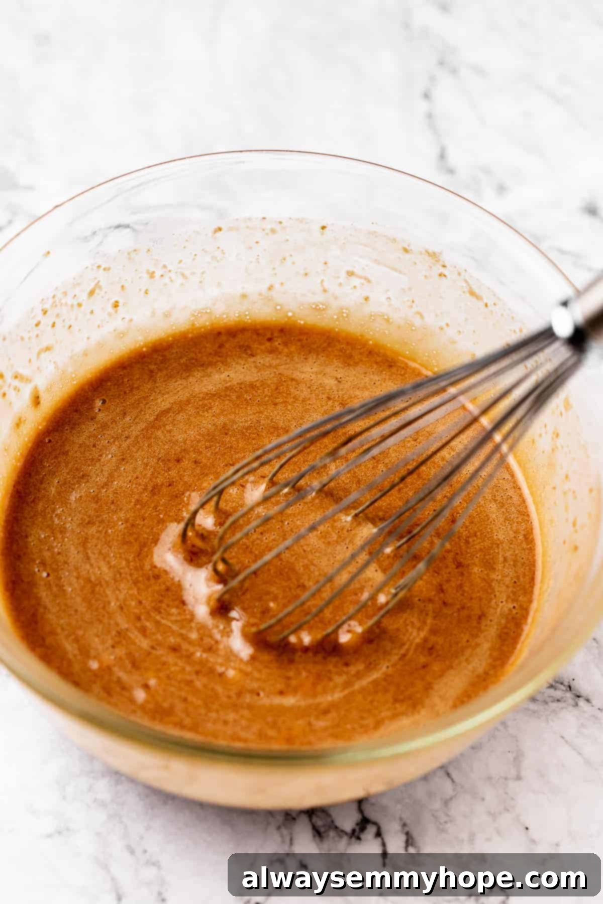 Fudgy Vegan Chocolate Banana Bread 5 Close-up of flax egg mixture with sugar and oil being whisked together in a mixing bowl.