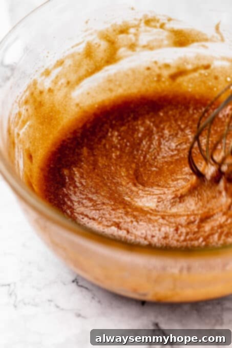 Fudgy Vegan Chocolate Banana Bread 7 All wet ingredients for banana bread, including mashed bananas, vegan milk, and vanilla, mixed together in a bowl.